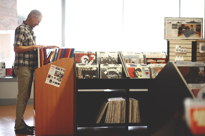WSU faculty member, Trevor Bond, searches the shelves of vinyl in Retro Riot for the last time prior to the stores closing on Aug. 13.