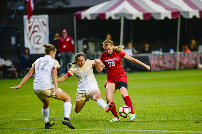 WSU sophomore forward Alysha Overland fends off a Colorado Buffalos defender in a match on Sept. 23. The Cougars late comeback attempt against the Cardinal fell short Thursday night in Palo Alto.