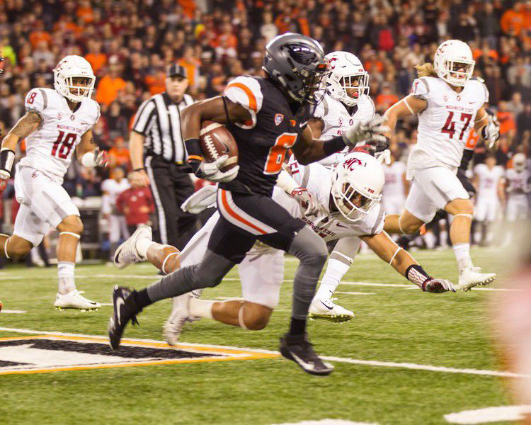 The Cougs pursue Oregon State wide receiver Victor Bolden Jr. during a game on Saturday, in which WSU secured its fifth straight win in conference play.