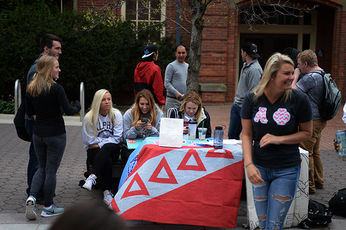 Students tabling at a Penny Wars event during Greek week on the Glenn-Terrell Friendship Mall on April 12. Participants competed by trying to get the most donated money.