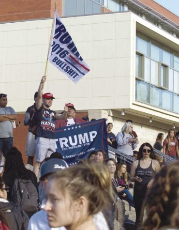 College Republicans President James Allsup waves a Trump flag in celebration of Donald Trump’s victory.