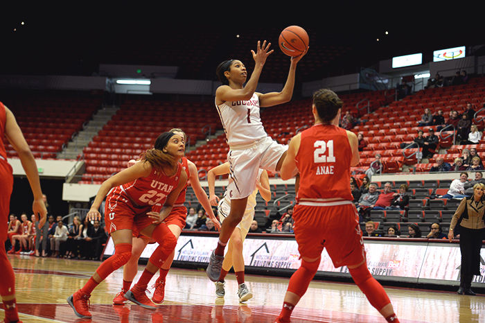 WSU junior guard Caila Hailey drives through Utah defenders on her way to the basket tonight.