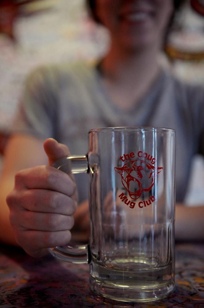 Becca Connor, The Coug assistant manager and bartender, with her crystal Mug Club mug on Monday.