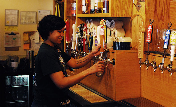 Stella Crumpton pours an Odell Runoff Red IPA for a customer on Monday at the Moscow Alehouse. Moscow Alehouse has a wide variety of beer on tap, their most popular is the Huckleberry Ale.