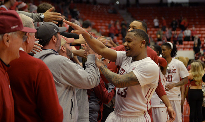 WSU players celebrate with Cougar fans after beating UW on Feb. 26. 
