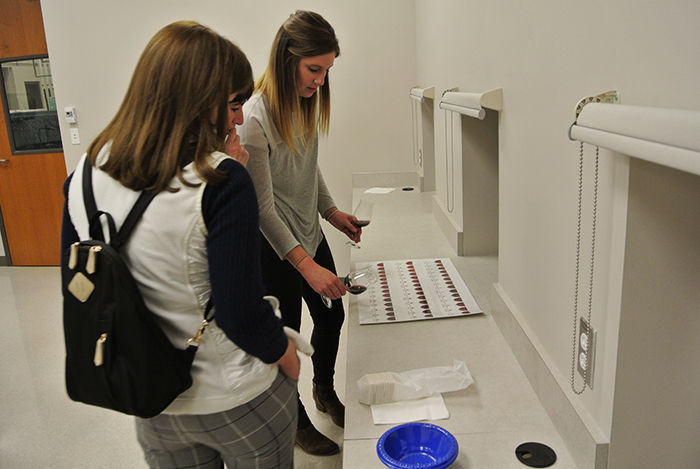 WSU Ph.D. candidate and wine analysis lab instructor Caroline Merrell with a student.