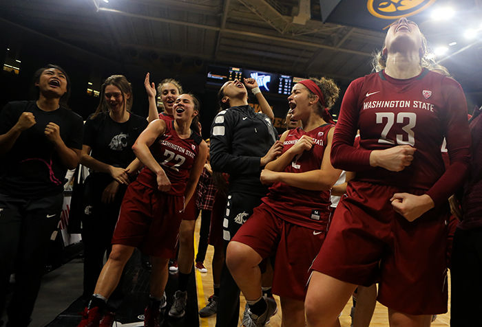 The women's basketball team celebrates after defeating the Iowa Hawkeyes 74-66 at Carver Hawkeye Arena in Iowa City on Sunday.