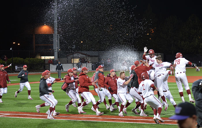 Members of the WSU baseball team rush the field after sophomore catcher Cory Meyer drew a bases-loaded walk to defeat the Huskies 5-4 in Friday’s series-opening game at Bailey-Brayton Field.