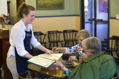Harmony Casey, a waitress at The Old European, serves Eileen Ball and Sue Benson on Thursday.