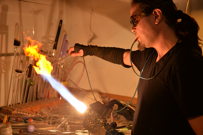 Mike Porter, owner and head lampworker at Glassphemy, makes a goblet from scratch on Friday.