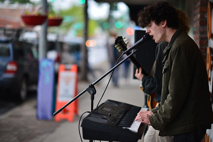 A street musician duo takes part in the 2016 Pullman ArtWalk by performing livemusic downtown.