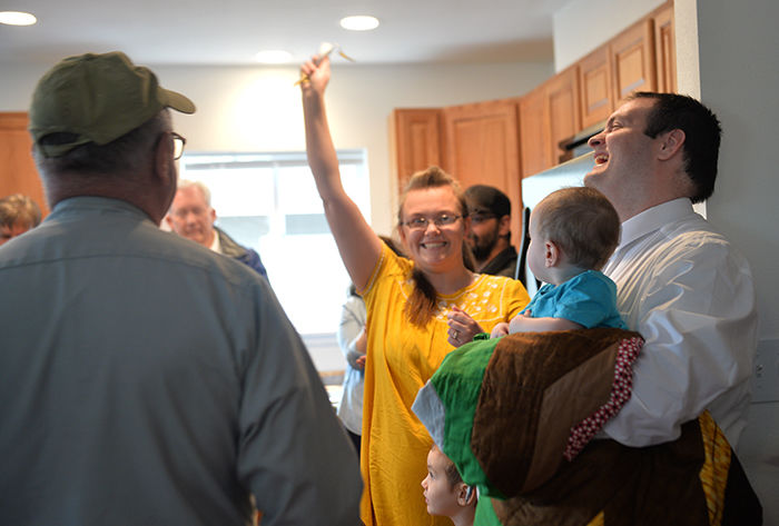 The Lloyd family celebrates getting the keys to their new home, built by Palouse Habitat for Humanity, at the house’s dedication on April 30.