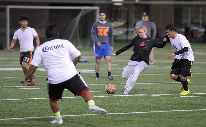 Participants compete in an intramural soccer match on April 28 at the practice field by Martin Stadium.