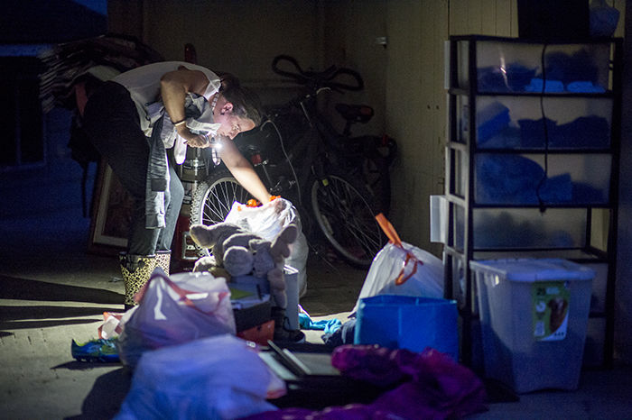 Stacey Smith-Colon searches through recovered belongings for her childrens clothing Wednesday evening after the fire in the garage of the damaged duplex.