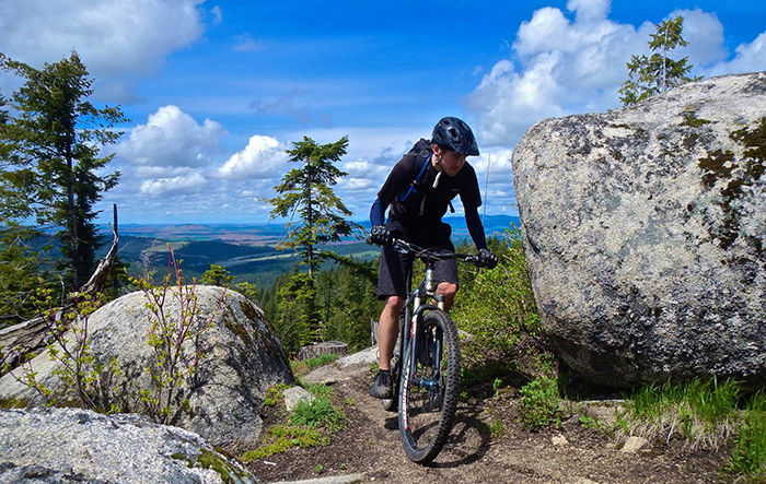 A member of the Moscow Area Mountain Bike Association (MAMBA) bikes through trail number five on Moscow Mountain.