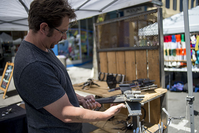 Travis Teigen shows off his partway finished X-wing Starfighter at his booth Saturday at the Moscow Farmers Market. 