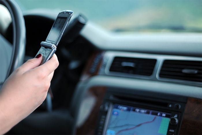Exceptions to the law include using the GPS on a mounted phone, built-in navigation systems and calling 911.