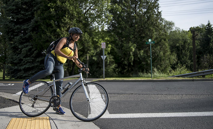 Pullman resident Sharhonda Brown rides along the new Cougar Climb bicycle path at the corner of Lentil Lane and E Spring Street. 