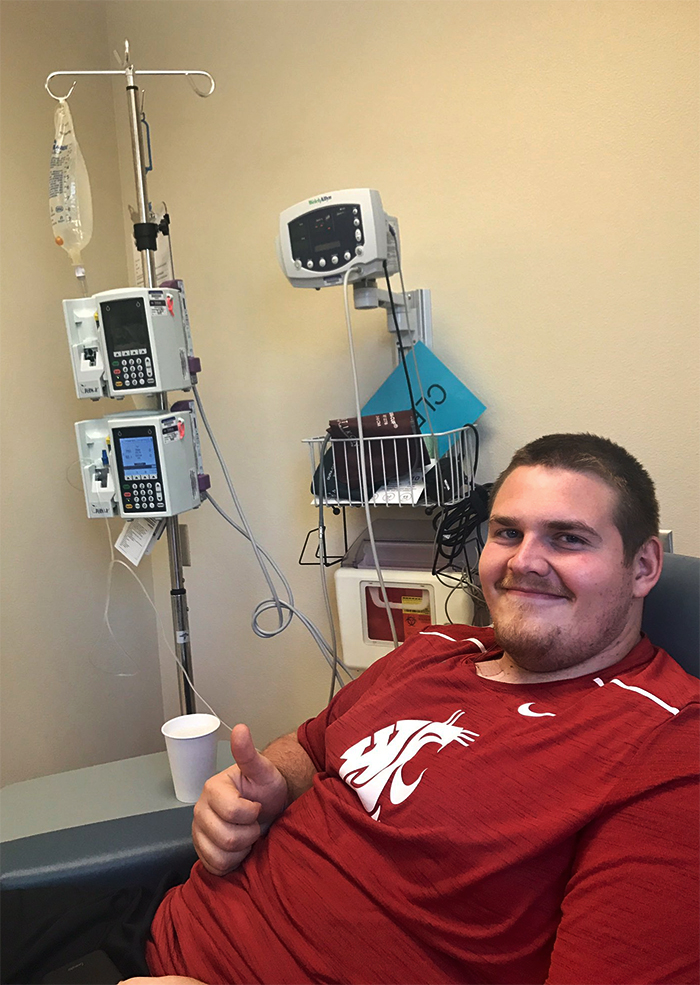 Riley Sorenson smiles and gives a thumbs up at St. Joseph Regional Cancer Center after a round of chemotherapy treatment for testicular cancer.