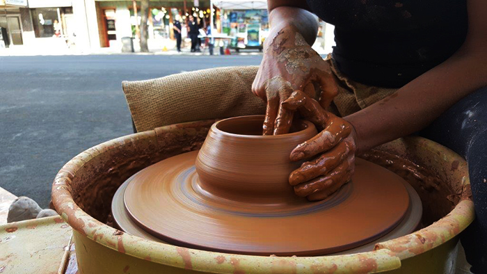 Ceramic artist Kassie Smith wheel-throwing a bowl during Moscows 2016 Artwalk.