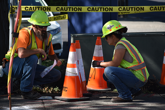 Jay Fuller, left, and Rachel Bigsby prepare traffic signs while new electrical is laid on June 5 on SE Paradise Street.