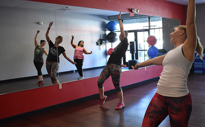 Zumba instructor Leah Haak Beck leads a group in a choreographed workout Friday at Snap Fitness. There are three instructors who guide the dance program throughout the week.