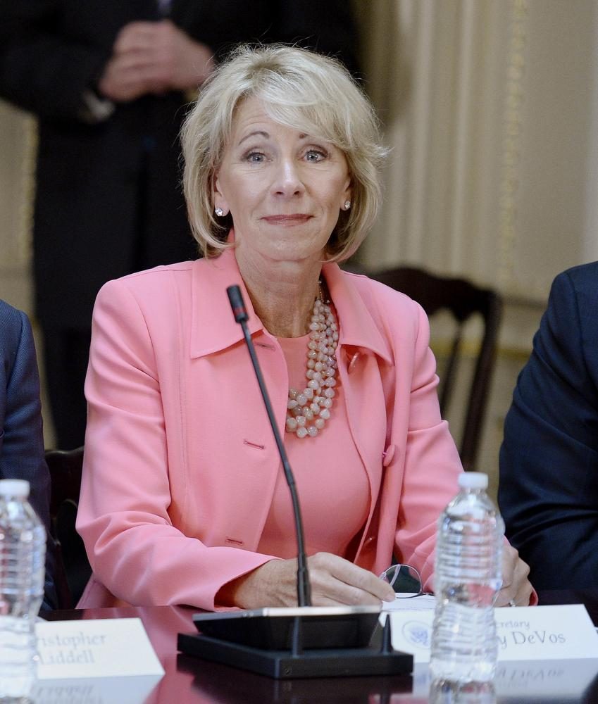 Education Sec. Betsy DeVos listens as U.S. President Donald Trump speaks during a strategic and policy discussion with CEOs 
in the State Department Library in the Eisenhower Executive Office Building on April 11, 2017, in Washington, D.C.

