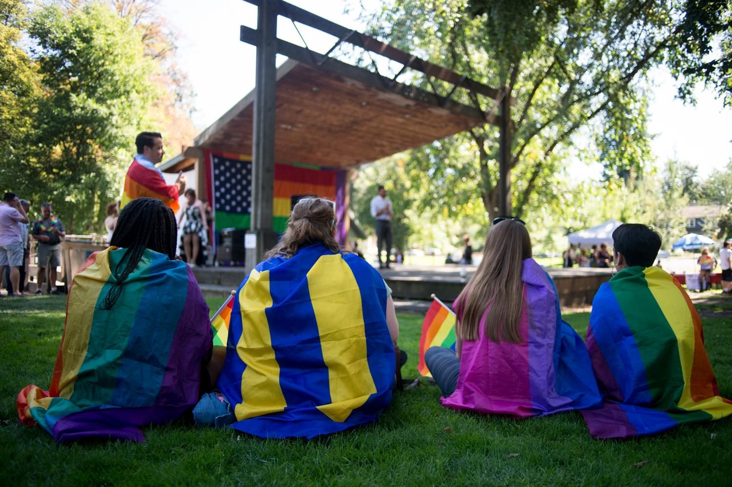 Pride march attendees listen to Mathew Southerland, a WSU student democrat who is running for congress against Cathy McMorris Rogers, speak about how he will help the LGBTQ community in Whitman County Saturday at the Palouse Pride Festival in Moscow.