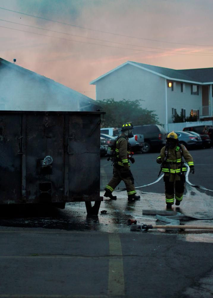 Firefighters respond Wednesday night to a dumpster fire at Campus Commons South.