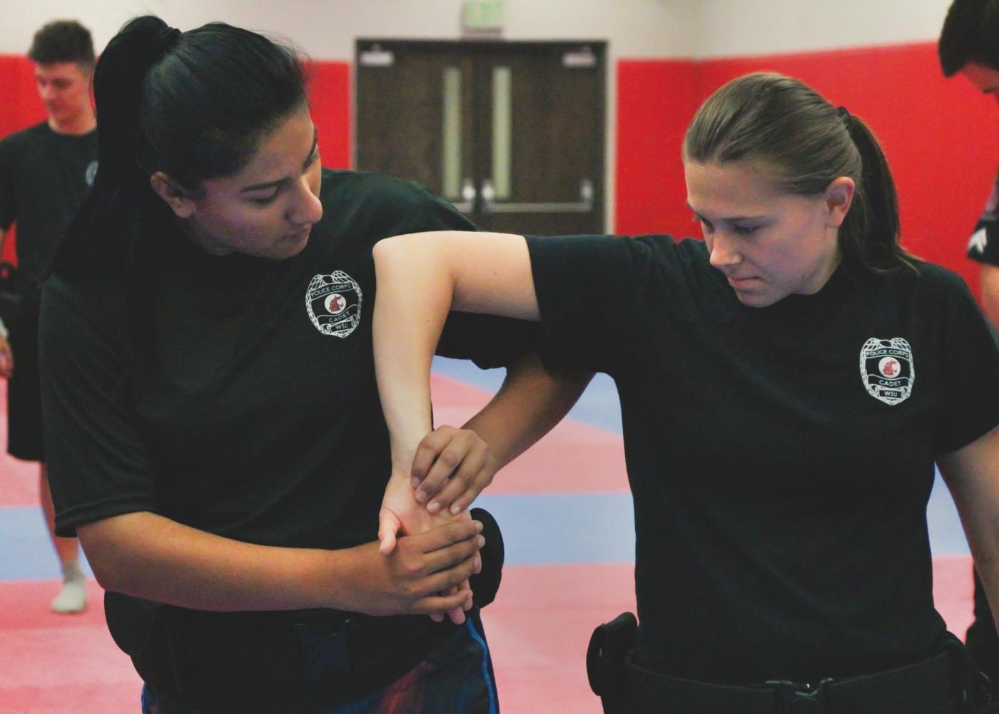 Sopohmore Maria Campos and senior Sammy Bill, both criminal justice majors, practice take downs during Defensive Tactics Training class in the Physical Education building on the morning on Monday, August 28th. 