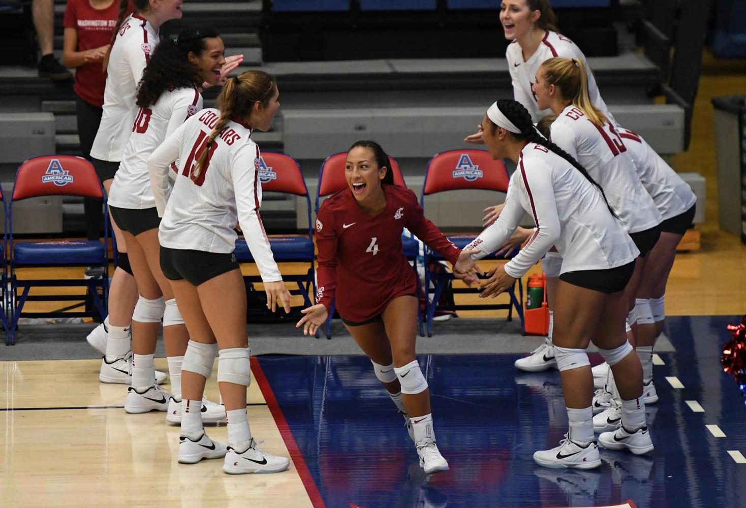 Sophomore defensive specialist Alexis Dirige high-fives teammates as she runs onto the court Monday evening in Washington D.C.
