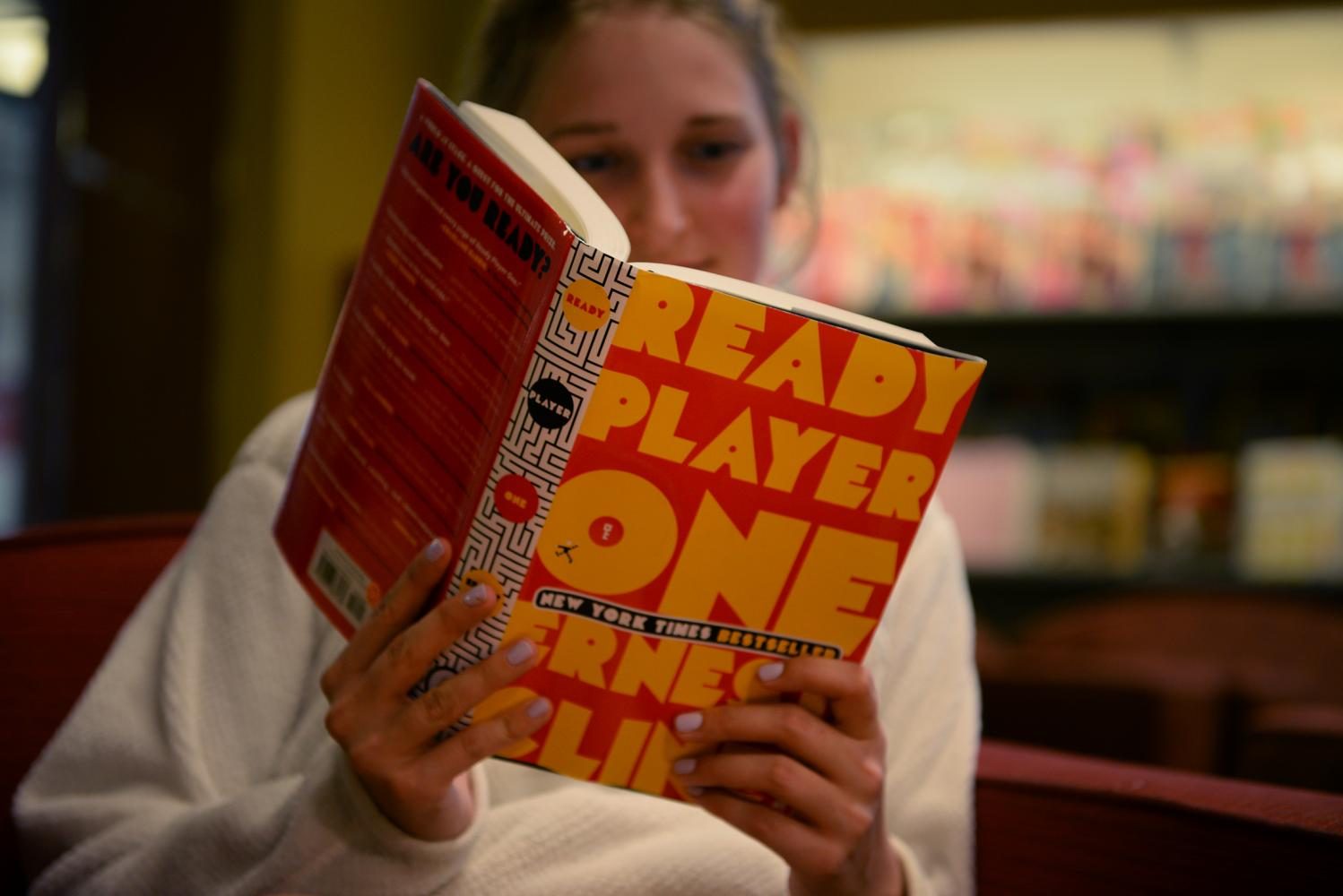 Elizabeth Dobbins, freshman, reads “Ready Player One” in The Bookie after class.