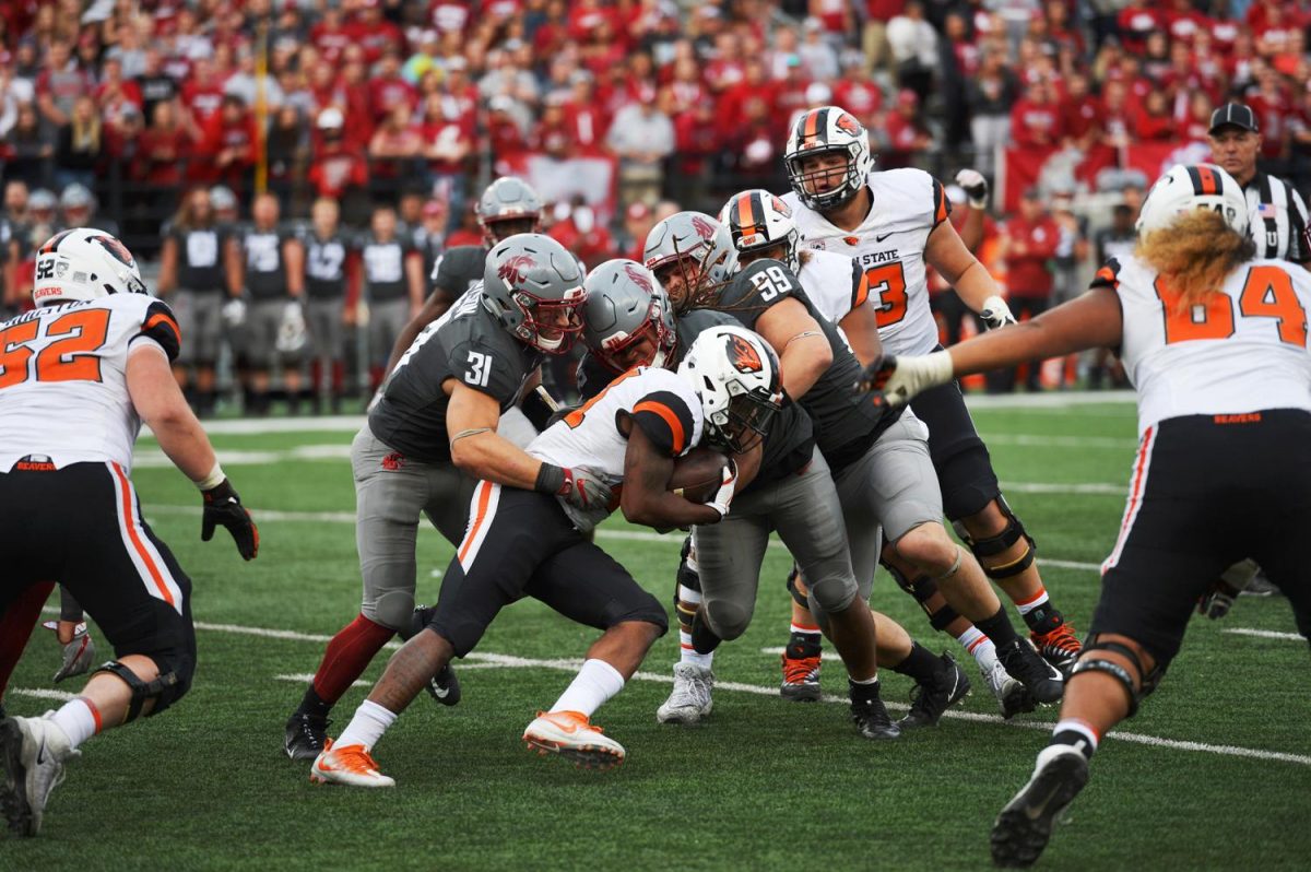 WSUs defense stops Oregon State sophomore running back Artavis Pierce for only a small gain Saturday at Martin Stadium.
