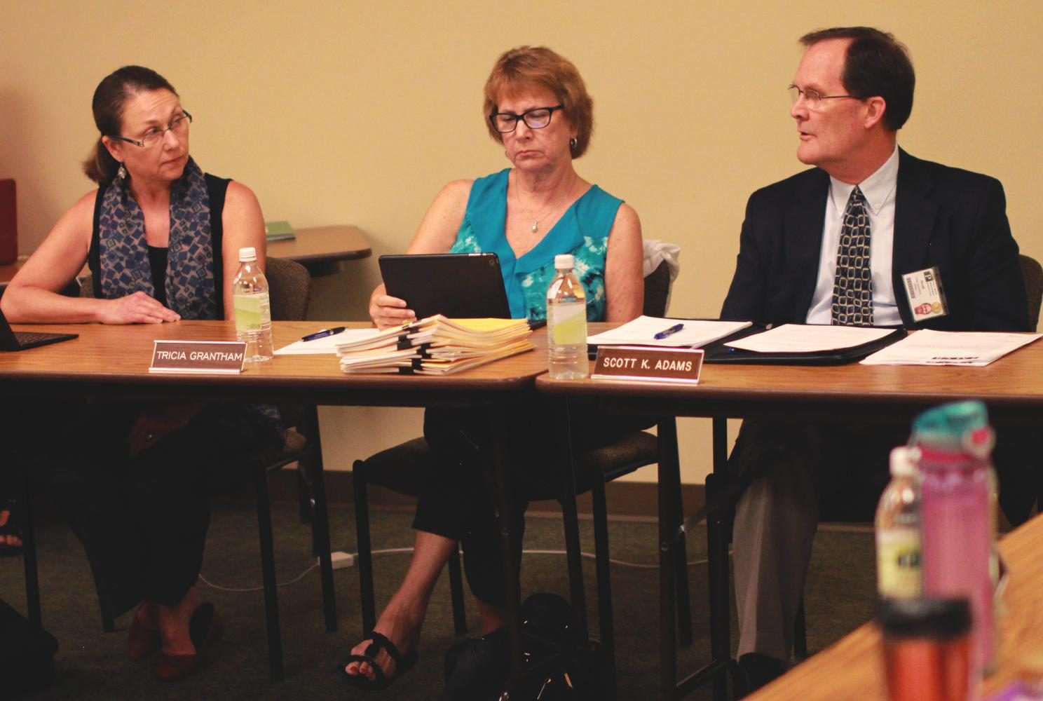 Board secretary Sandra O Keefe, president Tricia Grantham and Pullman Regional Hospital CEO Scott Adams discuss the hospitals proposed gender reassignment surgery Wednesday evening.