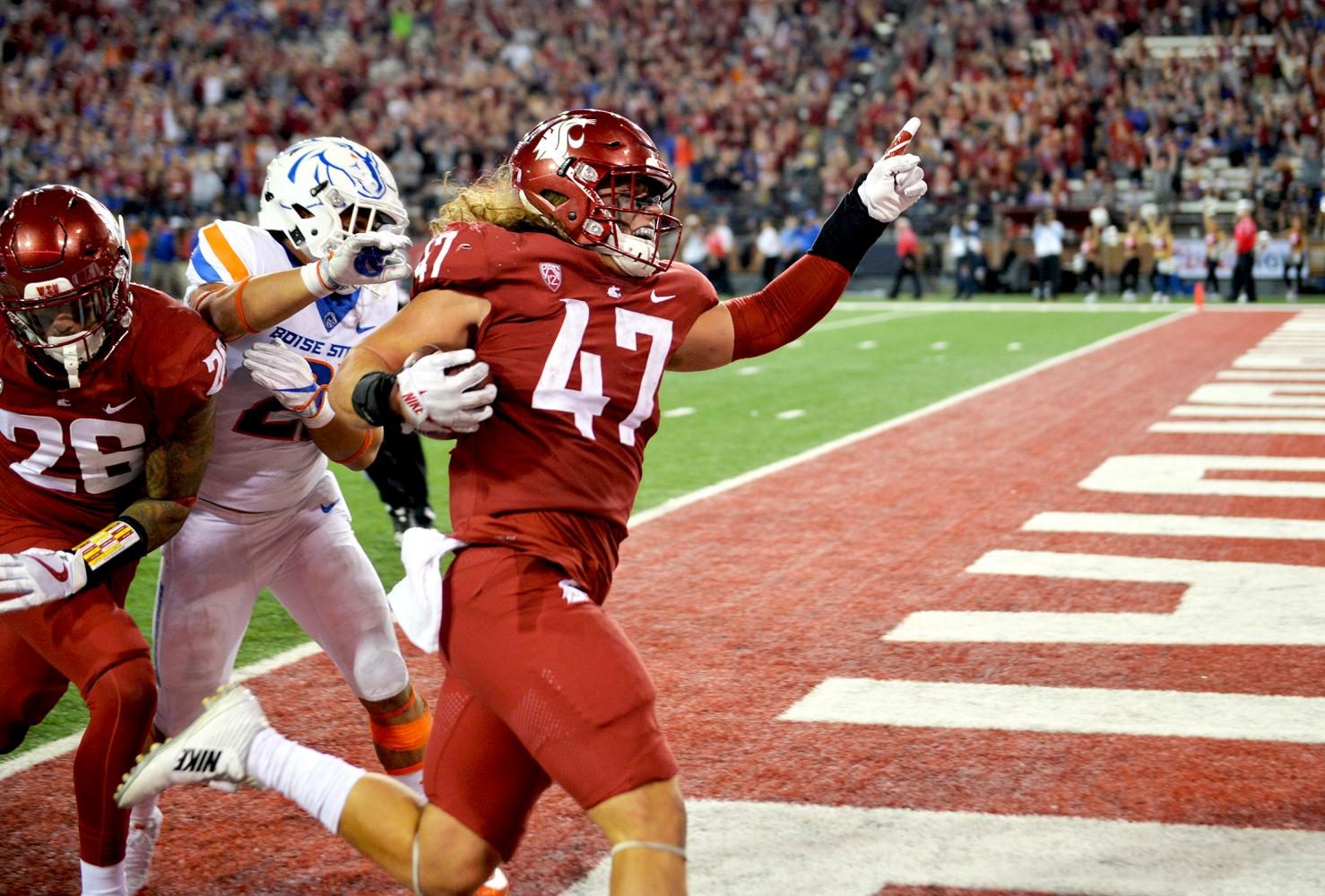 Then-redshirt senior linebacker Peyton Pelluer scores a touchdown against Boise State, bringing the Cougars within a touchdown of tying the game on Sept. 9, 2017.