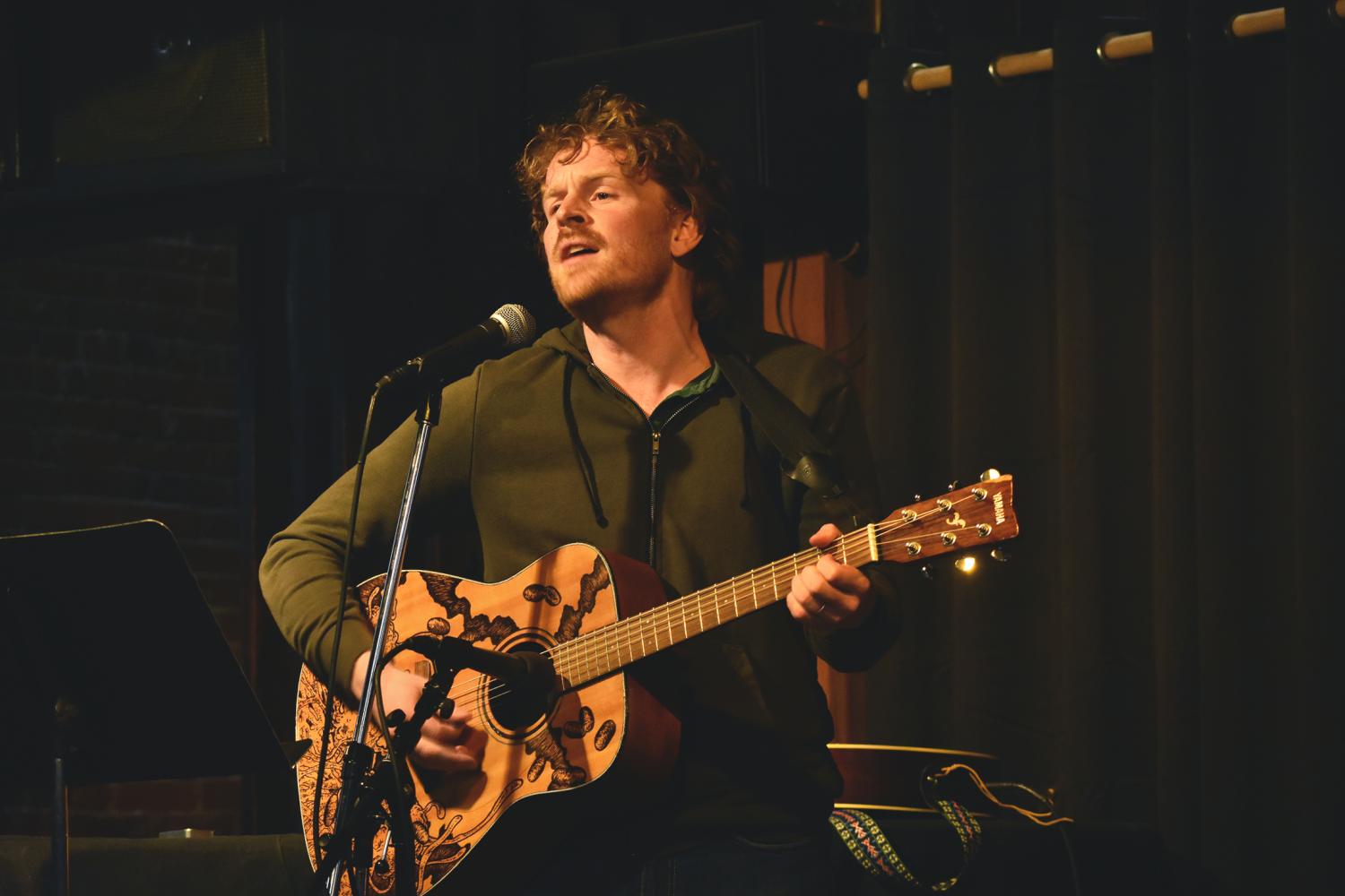 Isaac Backus took the stage for a solo performance at Rico’s Open Mic Night on Monday.