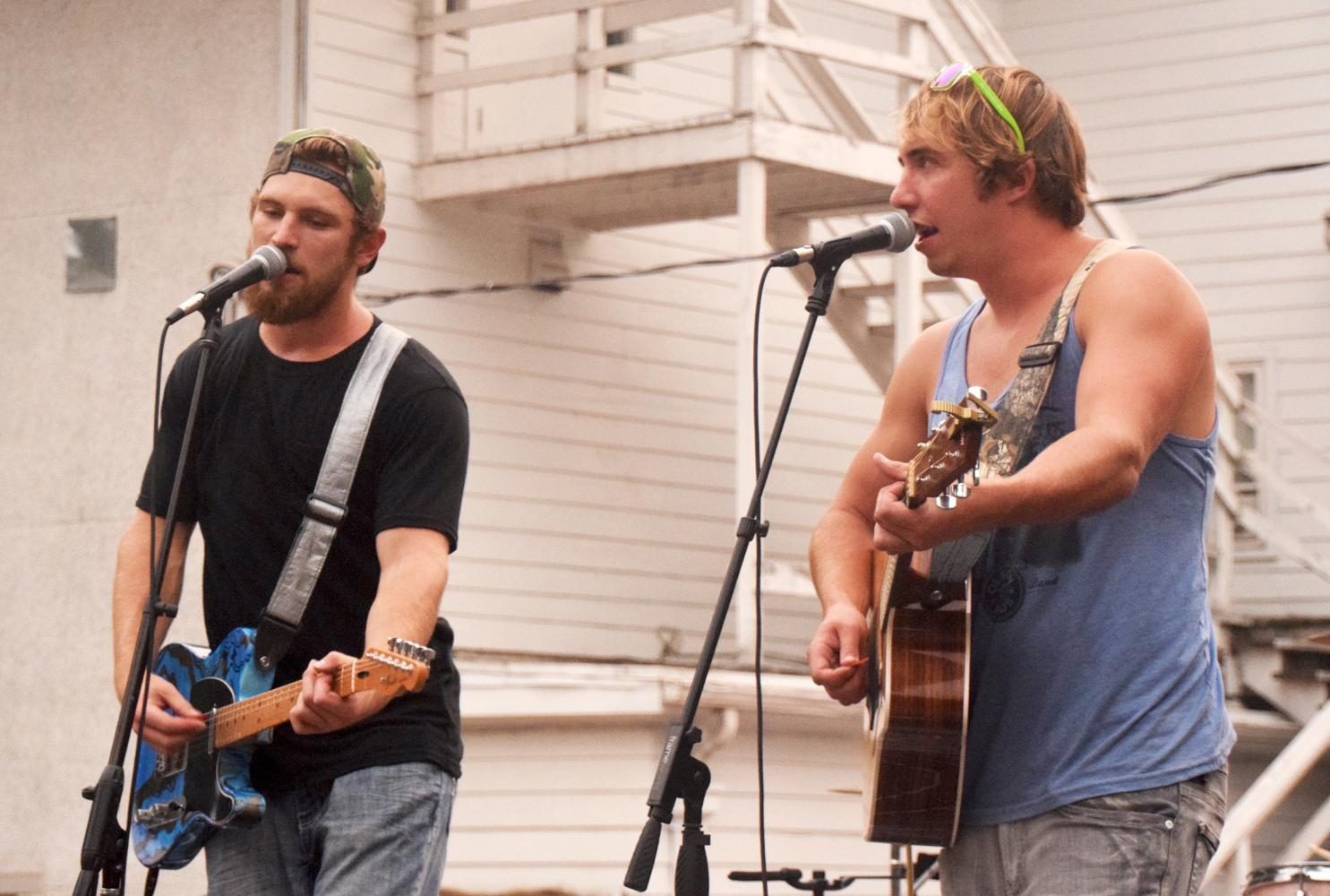 Luke Olson, left, and Isaac Olson of the Olson Bros Band jamming to original and iconic country songs in the Sigma Chi parking lot for West Fest 2017 on Thursday.