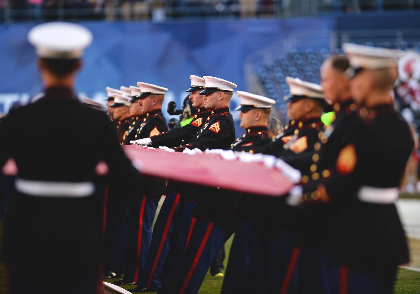 Members of the Marine Corps display the American flag during the Holiday Bowl pregame on December 27, 2016 at Qualcomm Stadium in San Diego, CA. 