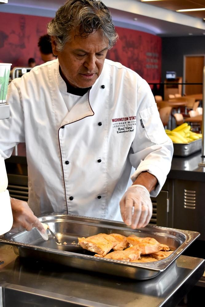 Senior Executive Chef Raul Vera prepares salmon for lunch Thursday in the Gray W Legends Lounge.