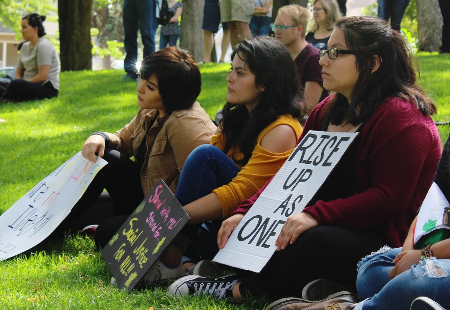Julissa Rivers (middle) and Isabel Robles (right) listen to speakers at the DACA rally

