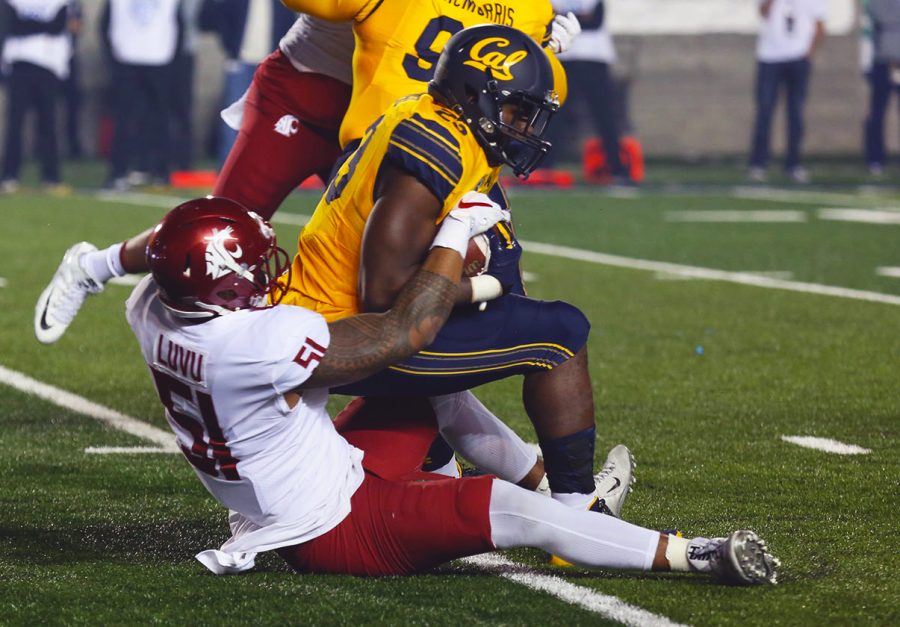 Senior linebacker Frankie Luvu drags a California offensive player during Friday nights game.