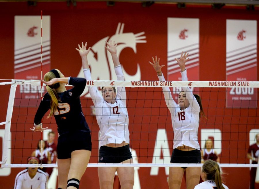 OSU senior outside hitter Mary-Kate Marshall, left, goes up for a kill against WSU junior opposite Claire Martin, 
center, and junior middle blocker Ella Lajos during Sunday’s match. WSU lost in the fifth set.