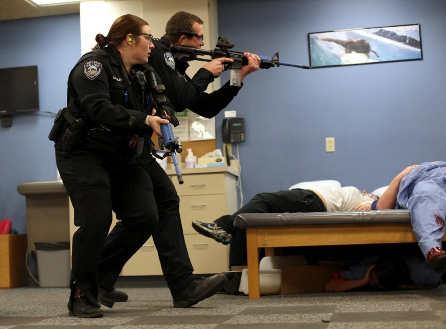 Pullman Police officers clear a room during an active shooter drill Oct. 6, 2013, at the Pullman Summit Therapy & Health Services building.