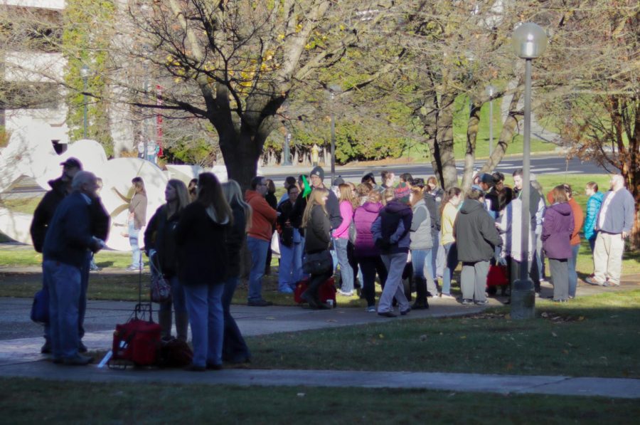 Student and faculty wait outside Bustad Hall on Tuesay morning after a mechanical issue prompted an emergency response.