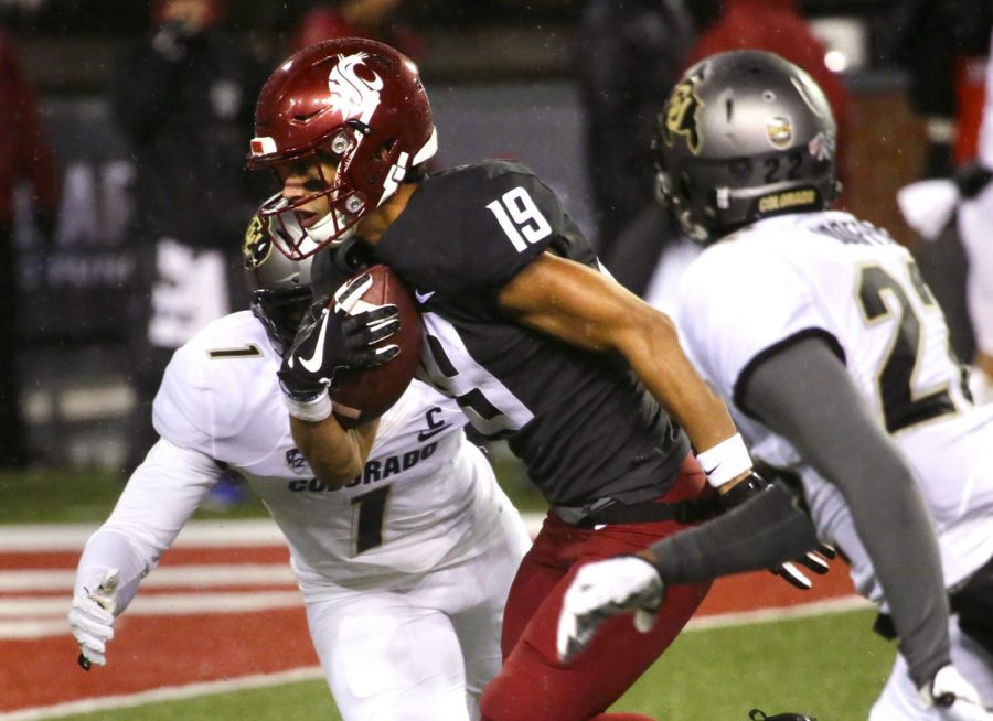 Redshirt sophomore wide receiver Brandon Arconado drives the ball into the end zone to score a touchdown for WSU, putting the Cougs up 14-0 with less than five minutes left in the first half.