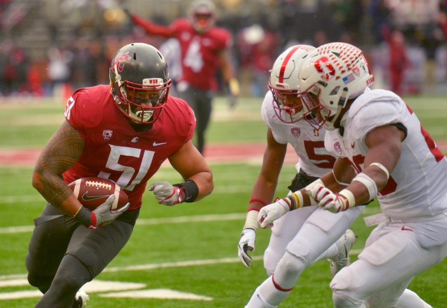 WSU senior linebacker Frankie Luvu eyes the oncoming Stanford defenders during Saturday’s game. The Cougars won 24-21.