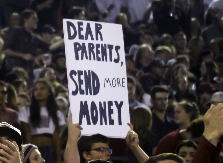 A fan sign during the WSU versus USC game on Sept. 29. It is common for college students to beg their parents for more money as they slave away at school.