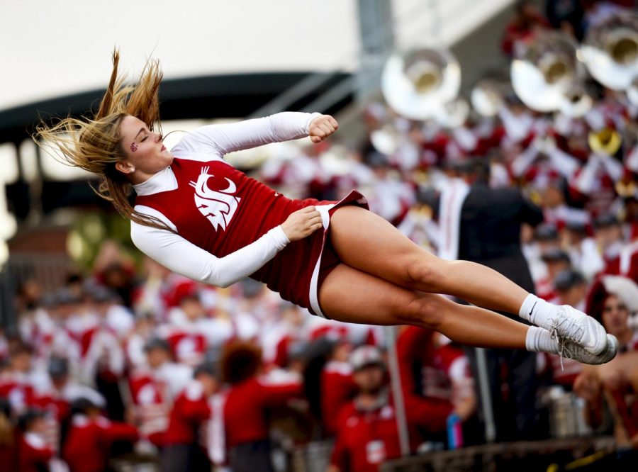 A WSU cheerleader is thrown into the air during a Sept. 23 football game against Nevada at Martin Stadium. 