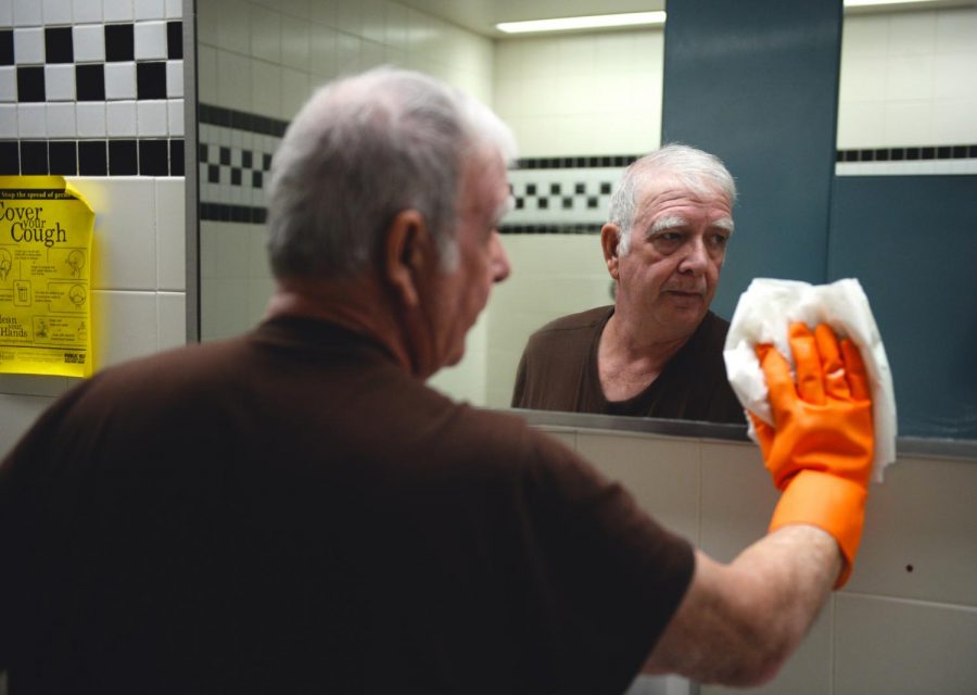 John Dawson, a custodial lead, wipes the mirror in a Food Quality Building bathroom. Rather than work steadily in one area, Dawson helps wherever needed. “I have a different challenge every day,” he says.