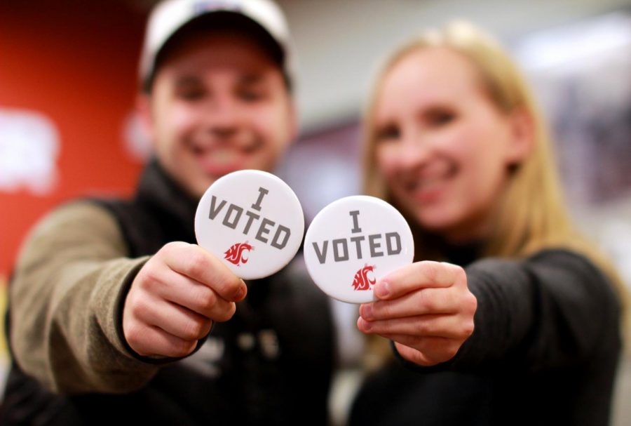 ASWSU director of communication Mitchell Weholt and senator Savannah Rogers hold up their I voted pins Tuesday afternoon in the CUB.